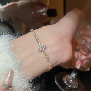 Macro view of gold flower bracelet with zircon inlays and elegant sparkling crystals