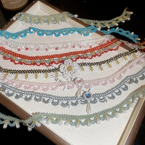 Elegant stainless steel choker with crystal beads, faux pearls, and floral weave patterns