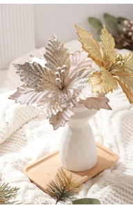 Close-up of sparkling champagne gold velvet Christmas flowers with glitter on a white vase
