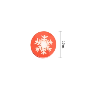 Close-up of a 10mm red polymer clay bead with a white snowflake pattern for DIY crafts