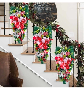 Detail of Christmas candy upside-down trees with red bows and berries on a stair railing