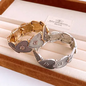 Retro elastic heart bracelet with vintage gold and silver embossed floral patterns