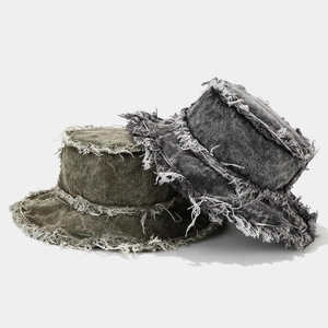 Frayed edge denim bucket hat in dark grey and olive green featuring a vintage washed style