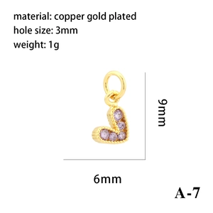 Macro view of 18K gold plated heart charm with purple cubic zirconia and size details