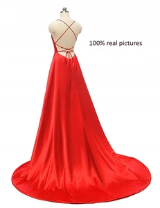 Detailed back view of red satin evening gown featuring criss-cross straps and backless cut