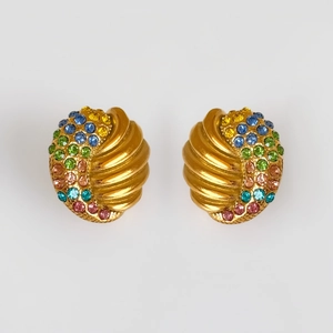 Detailed shot of vintage gold spiral earrings with colorful emerald cut zircon stones