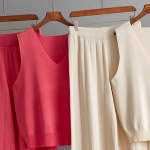 Detailed texture of women's knit V-neck vest and wide-leg trousers in vibrant fuchsia