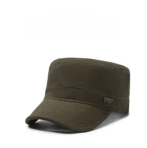 Detail of olive green military flat top cap showing sports style metal plaque and stitching