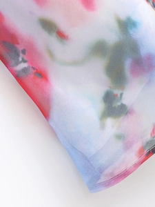 Detailed macro shot of floral watercolor print fabric with breathable woven texture