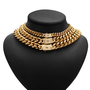 Three gold Cuban link chains with diamond clasps on a black mannequin bust
