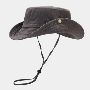Detail of a dark taupe sun hat featuring a wide wavy brim and bronze metal snap buttons