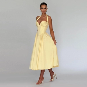 Detail of the light yellow corset-style bodice with elegant halter bow and premium fabric