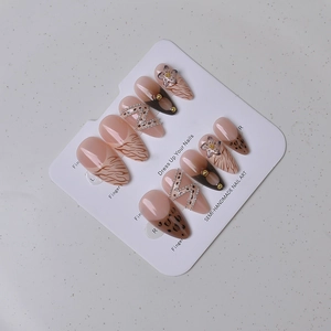 Detailed long almond nails with leopard print, 3D floral art, and gold bead accents