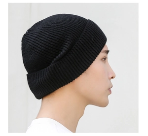 Close-up of thick knit beanie in black featuring high-quality ribbed wool texture