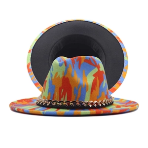 Detail of multi-color graffiti fedora hat featuring gold chain link and wide brim