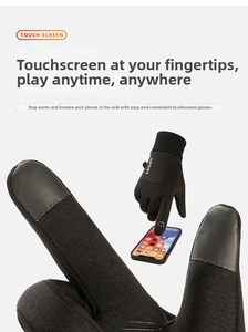 Close-up of black winter gloves with touchscreen sensitive fingertips for smartphones.