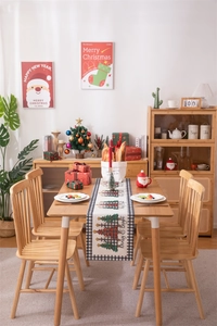 Modern Christmas table runner with festive tree print and buffalo plaid border detail