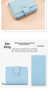Detail of light blue lychee pattern leather wallet with snap button and metal zipper