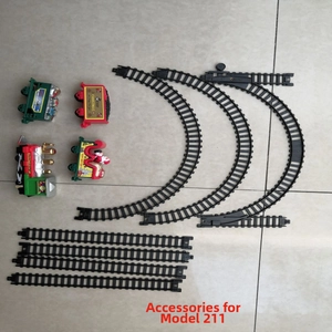 Flat lay of retro Christmas train set with engine, cars, and black plastic track parts