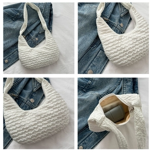 Detailed views of a white pleated dumpling bag with wavy texture and interior structure