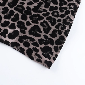 Close-up of leopard print mesh top with precise double-needle stitching and fabric detail