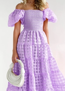 Close-up of purple plaid off-shoulder dress with puff sleeves and tiered skirt detail