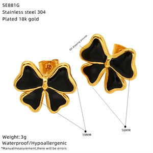 Detail view of 18K gold-plated stainless steel bow earrings with black oil dripping process
