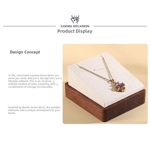 Detail of clover pendant necklace with purple gemstone on a wooden display stand
