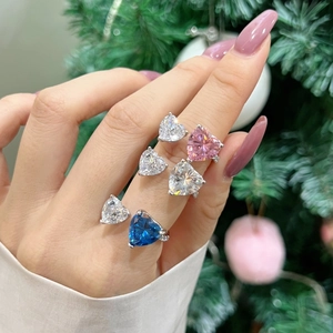 Close-up of elegant S925 silver rings with heart-shaped zircon stones in various colors