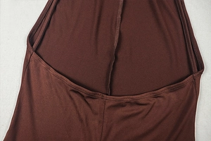 Detail of brown slip dress showing fine stitching and smooth silk-like fabric texture