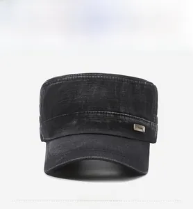 Close-up of black washed denim cadet hat featuring a silver metal brand plaque detail