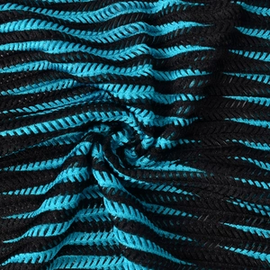 Macro view of blue and black hollow-out knitted mesh fabric with dynamic 3D texture