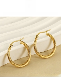 Close-up of twisted gold hoop earrings with 18K vacuum plating and durable texture