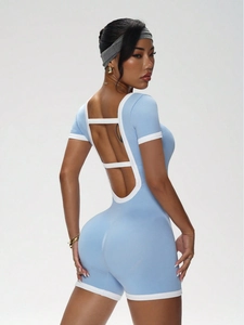 Detail view of seamless light blue yoga jumpsuit with contrast piping and open back design