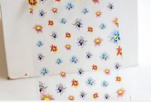 Close-up of 5D watercolor flower nail art stickers with various colorful floral patterns