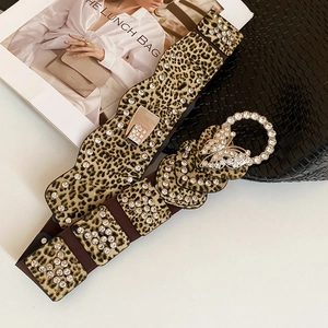 Detail of leopard print waist belt with sparkling rhinestones and butterfly buckle