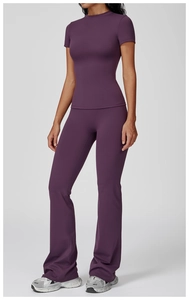 Detail of high-waisted flared yoga pants and slim-fit round neck top in deep purple
