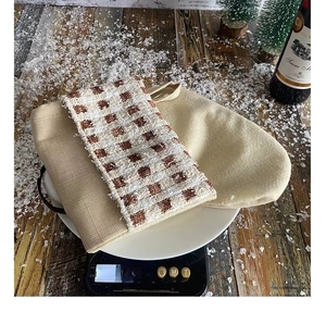 Macro detail of thick plaid knit fabric texture and linen gift bag for Christmas stocking