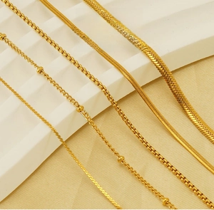 Close-up showing different gold chain textures including square box and ball styles
