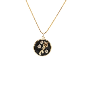 Minimalist gold necklace with a black enamel tulip and star pendant and zircon stones