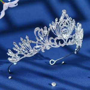 Elegant silver Baroque bridal crown with crystal heart pattern on dark blue silk backdrop