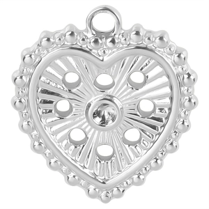 Macro shot of silver heart pendant with radiant hollow design and central clear stone