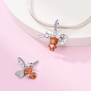 Detail of silver angel bear and Peace envelope charms on a pink rhinestone snake chain
