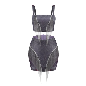 Sparkly purple two-piece set featuring sequin crop top and mini skirt with silver tassels