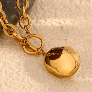 Detailed shot of 18K gold plated chain with OT clasp and irregular metal pendant