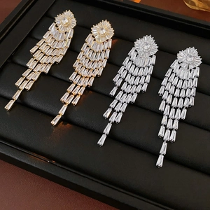 Art Deco style geometric tassel earrings with glittering zircons in gold and silver finish