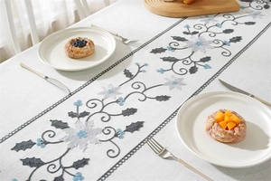 Detail of embroidered floral table runner with tassels and hollowed-out edges