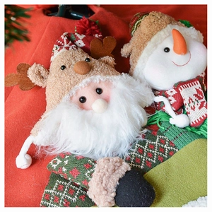 Detail of 3D plush Santa and Snowman figures with knitted textures and festive colors