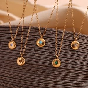 Close-up of 18K gold plated necklaces featuring colorful round birthstone pendants