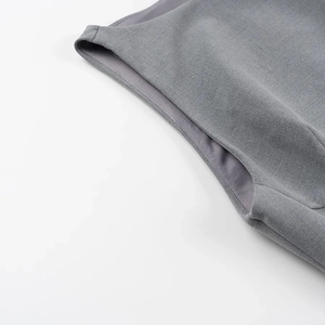 Close-up of fine grey twill fabric showing detailed stitching and high-quality texture